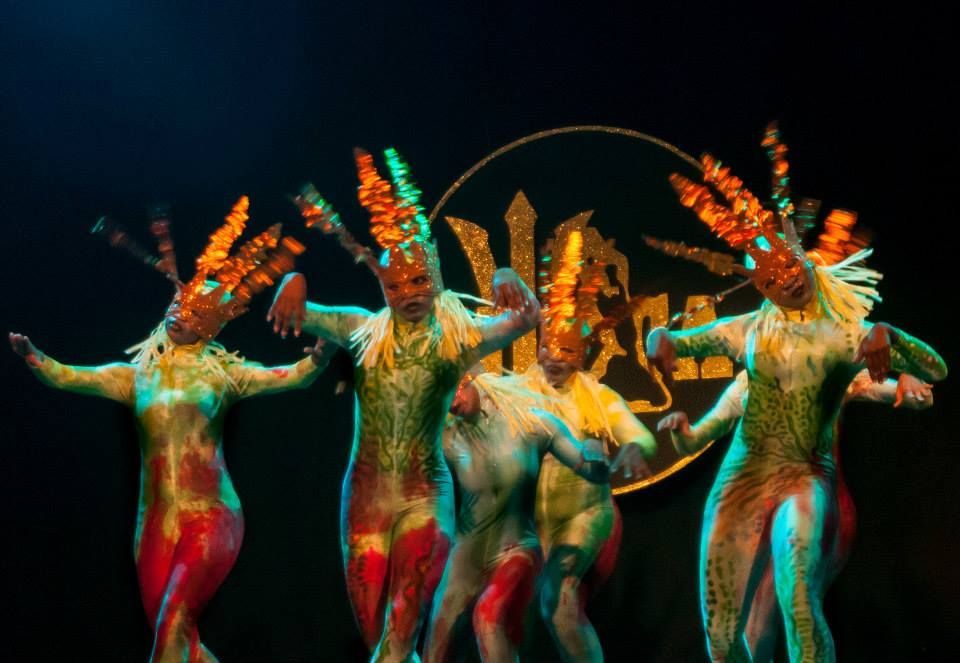 Dancers in painted bodysuits and antelope headdresses